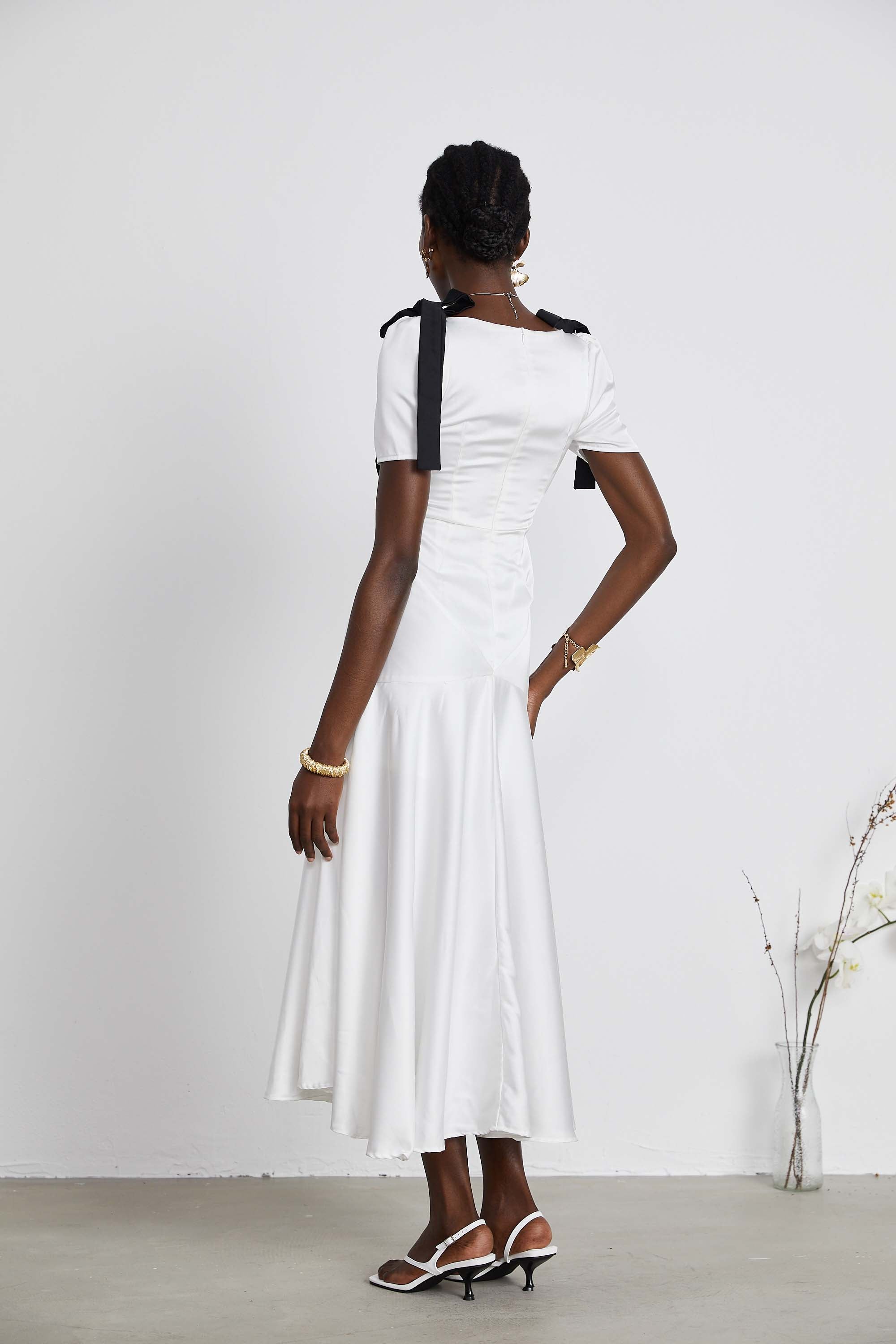 White satin V-neck midi dress with black bow shoulder straps