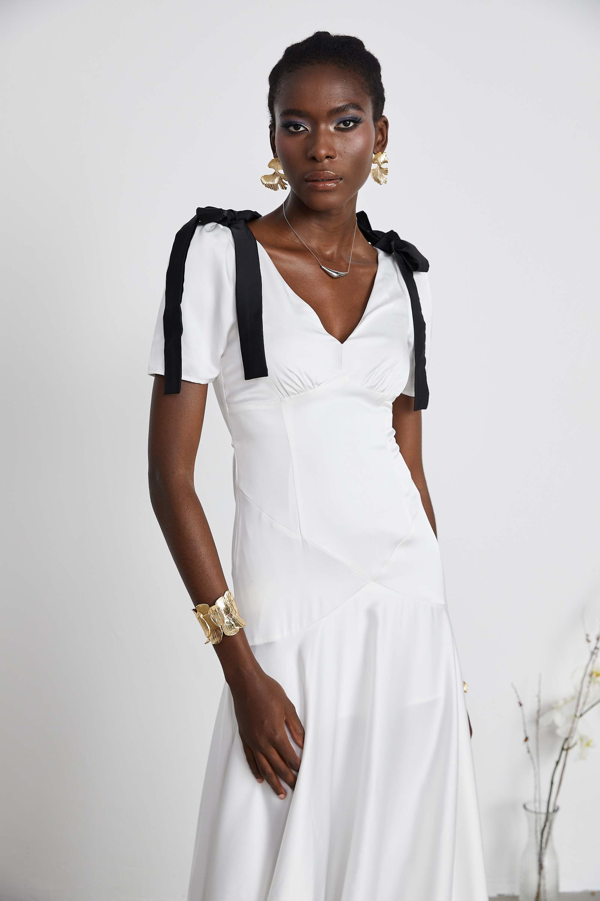 White satin V-neck midi dress with black bow shoulder straps