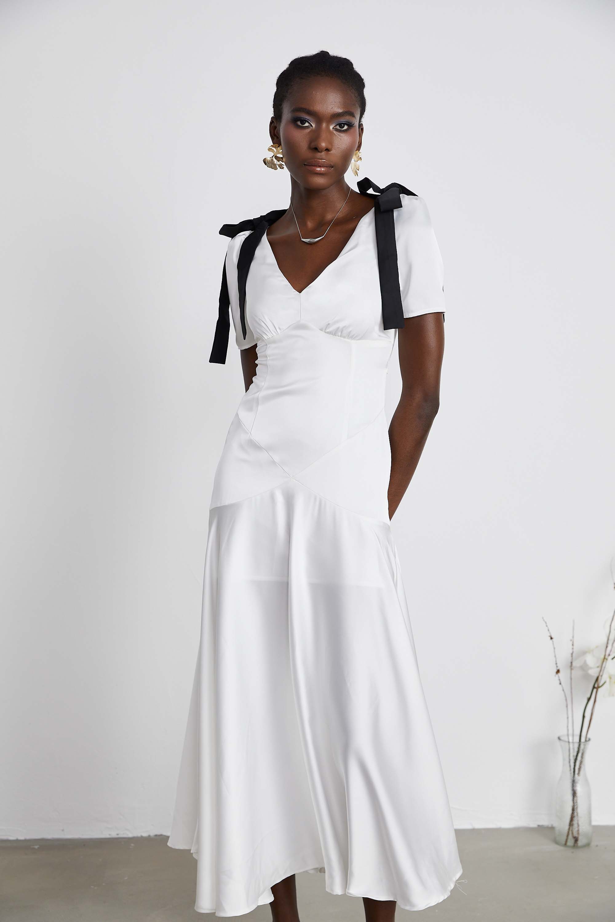White satin V-neck midi dress with black bow shoulder straps