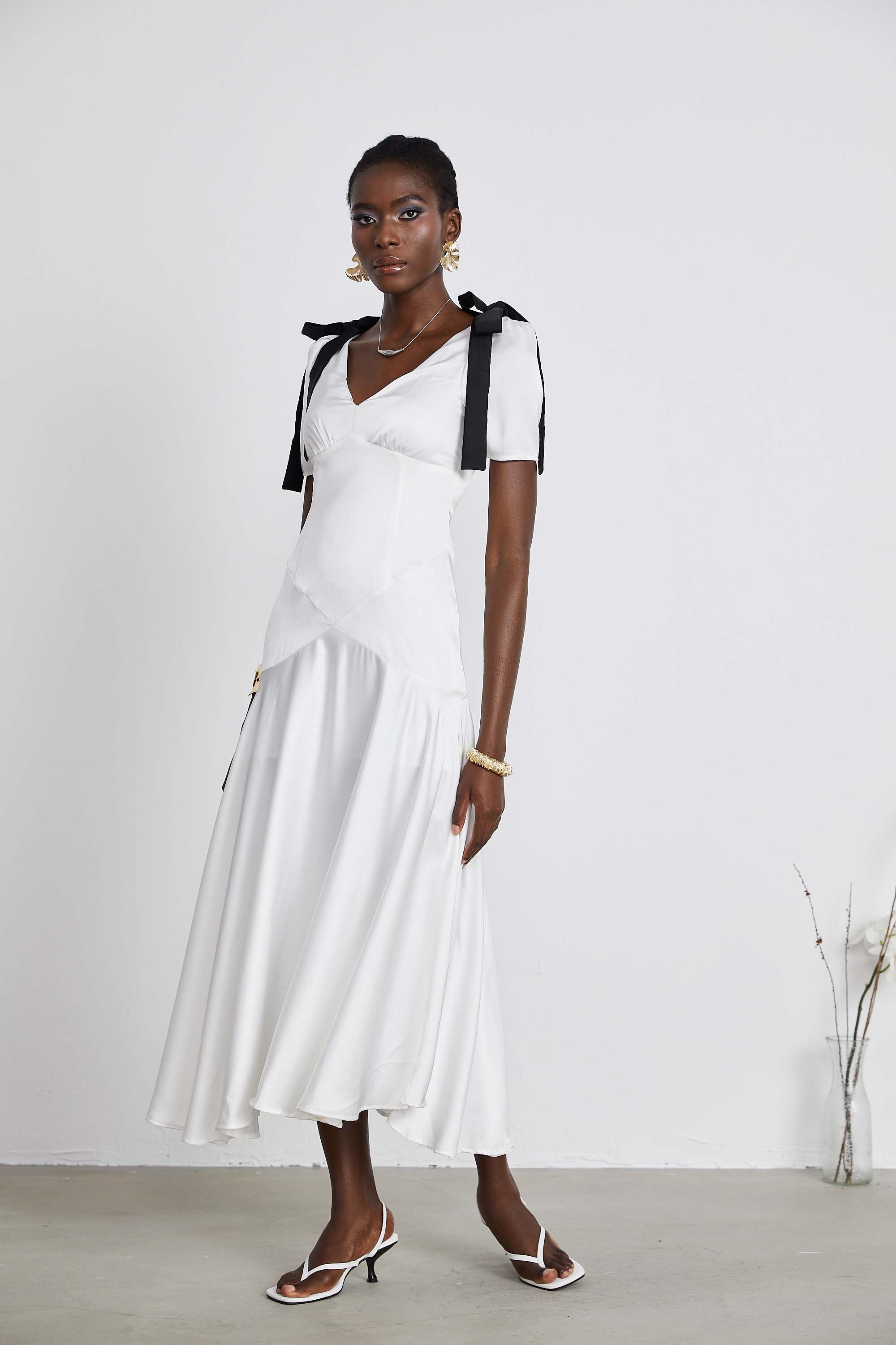 White satin V-neck midi dress with black bow shoulder straps