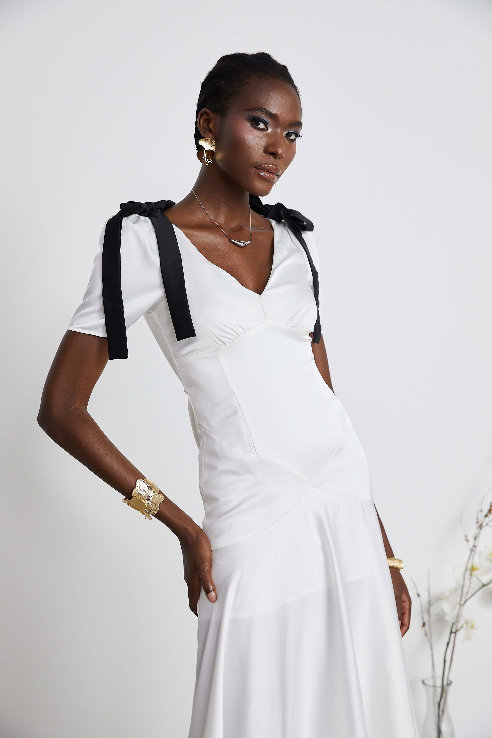 White satin V-neck midi dress with black bow shoulder straps