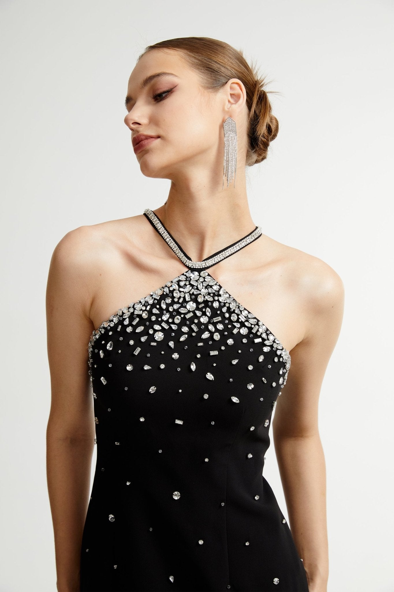 Black halter mini dress embellished with crystals on the neckline and bodice