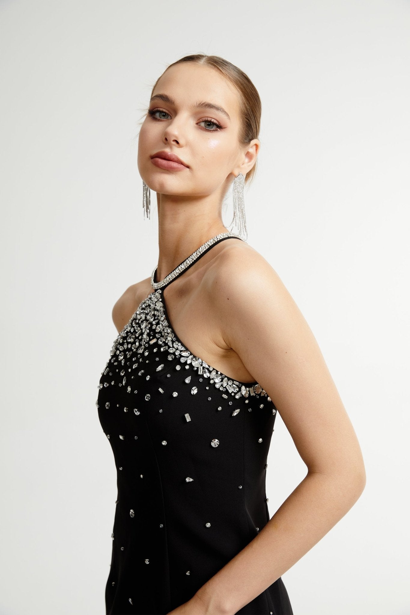 Black halter mini dress embellished with crystals on the neckline and bodice