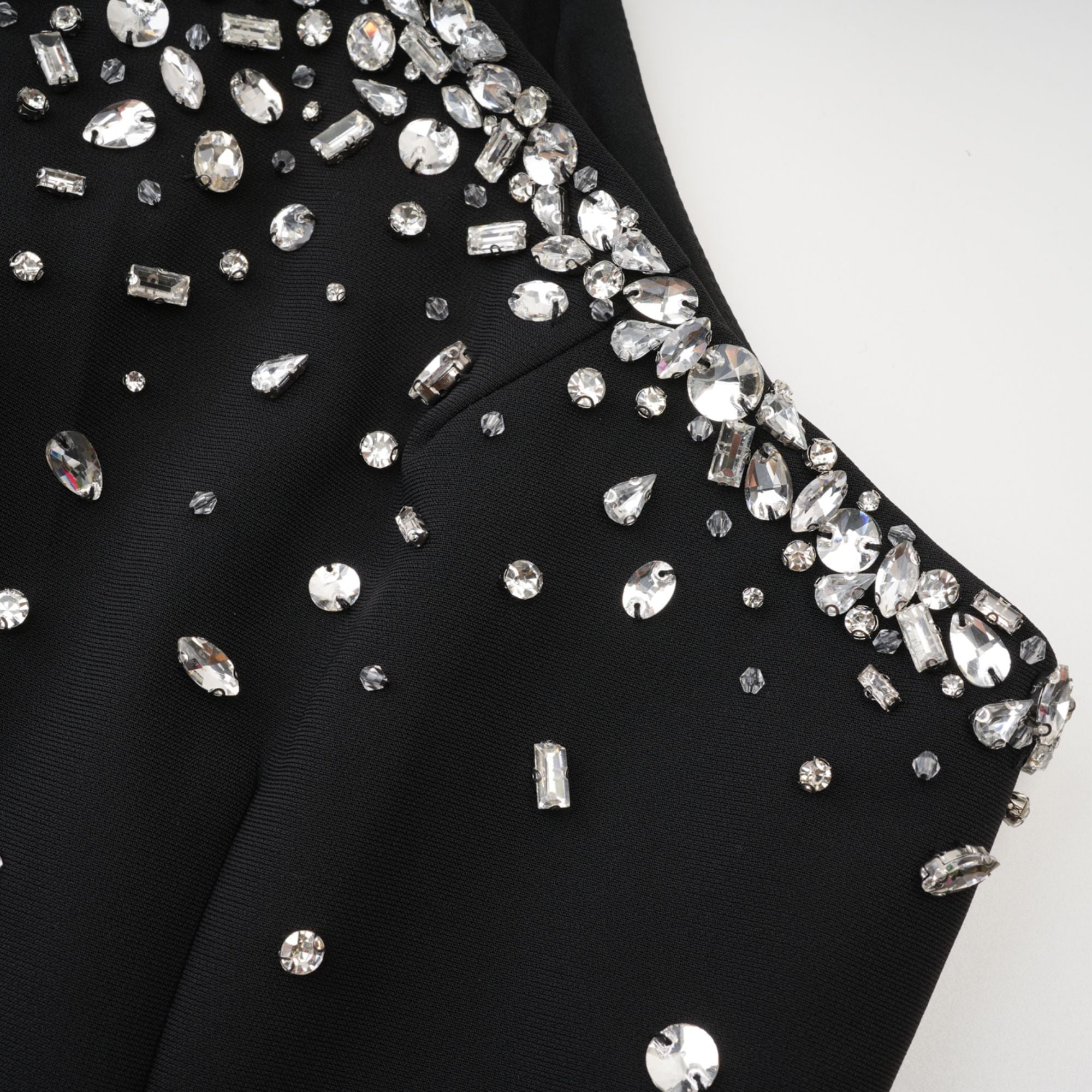 Black halter mini dress embellished with crystals on the neckline and bodice